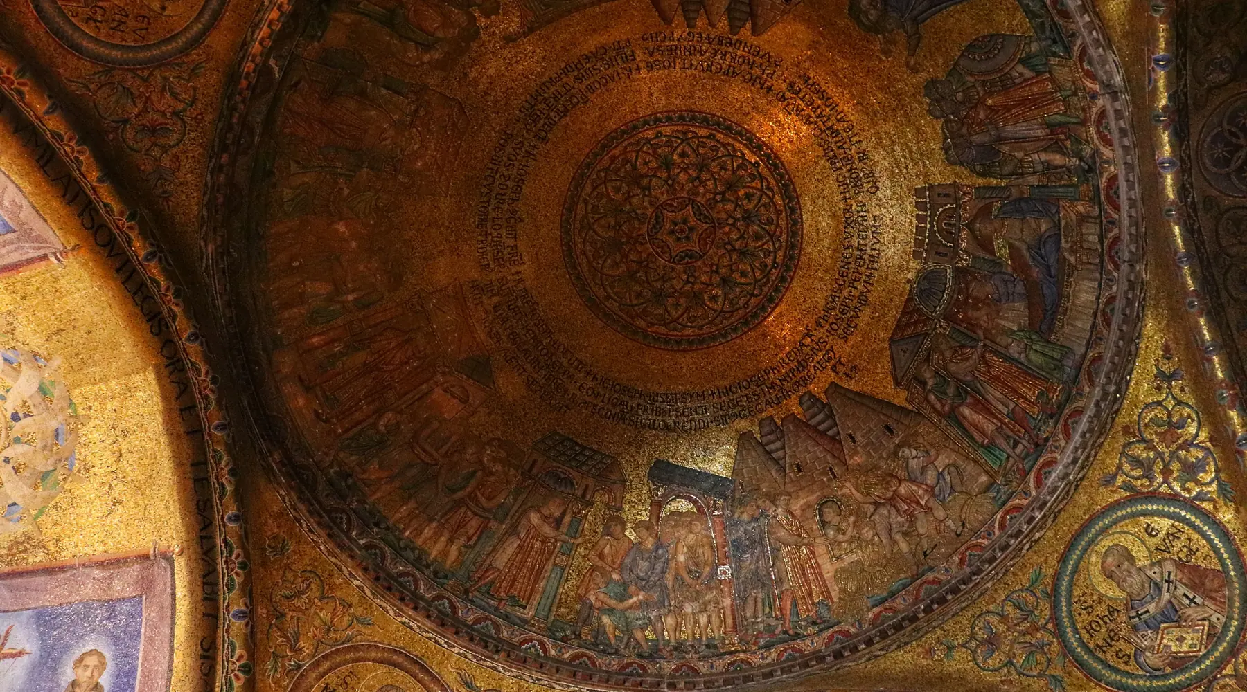 Golden Byzantine mosaic inside a dome of St Mark's Basilica, showing biblical figures in a ring of gold tesserae