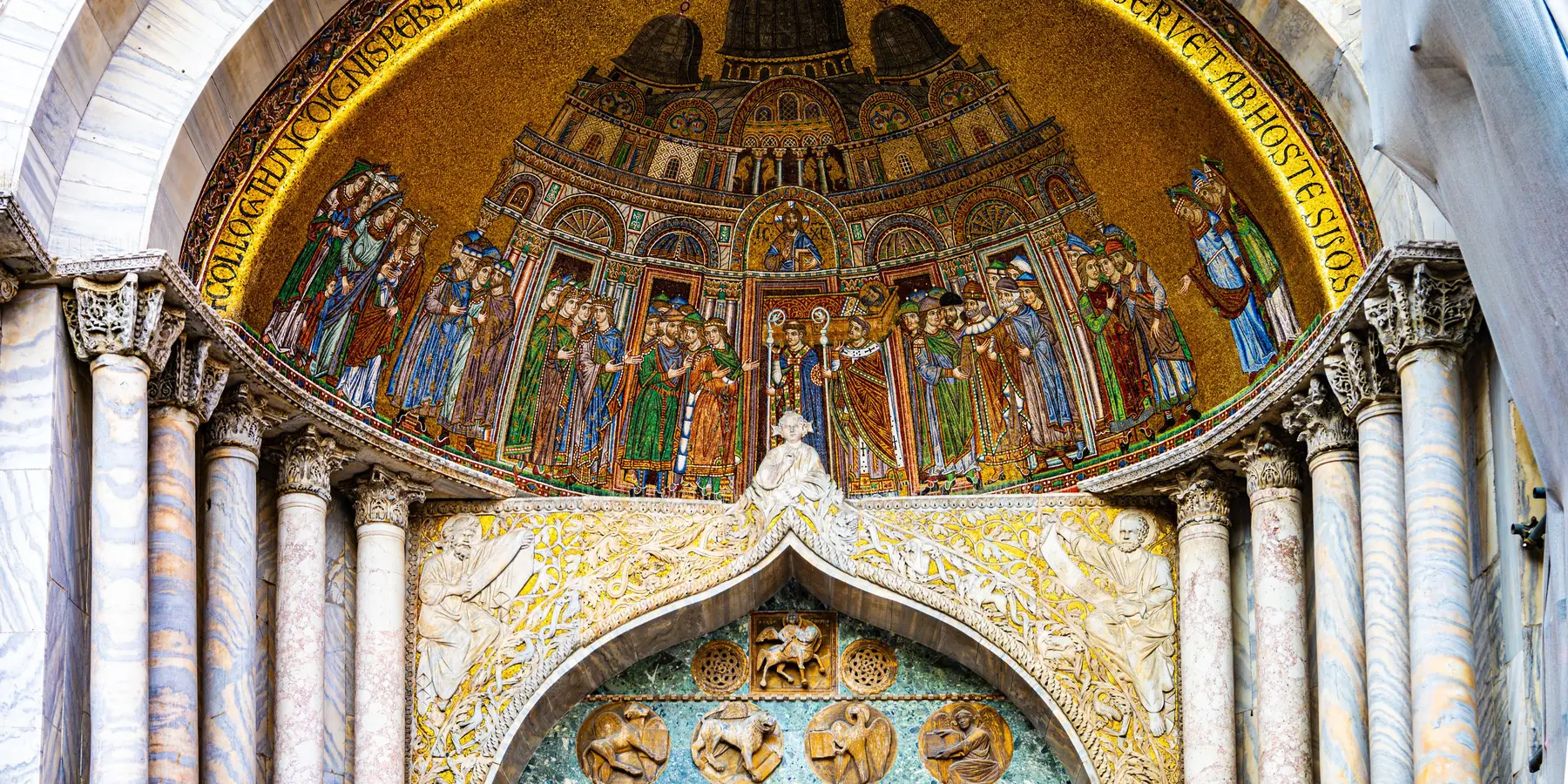 Golden mosaic lunette above a portal of St Mark's Basilica depicting a Byzantine procession